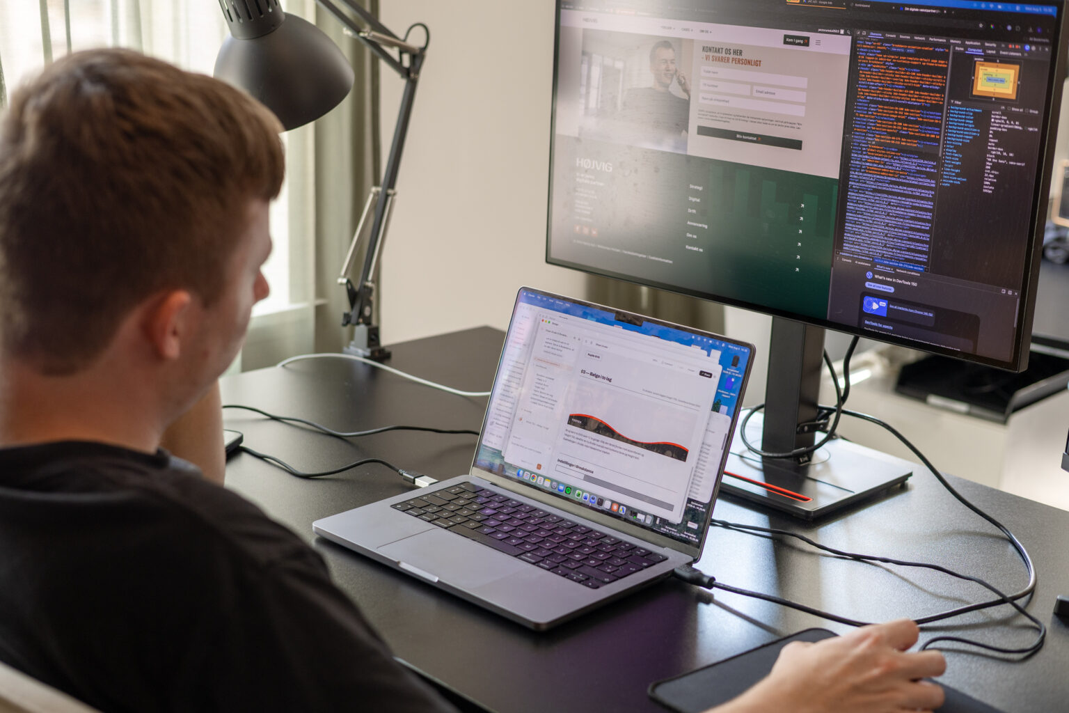 Medarbejder arbejder ved computer med flere skærme